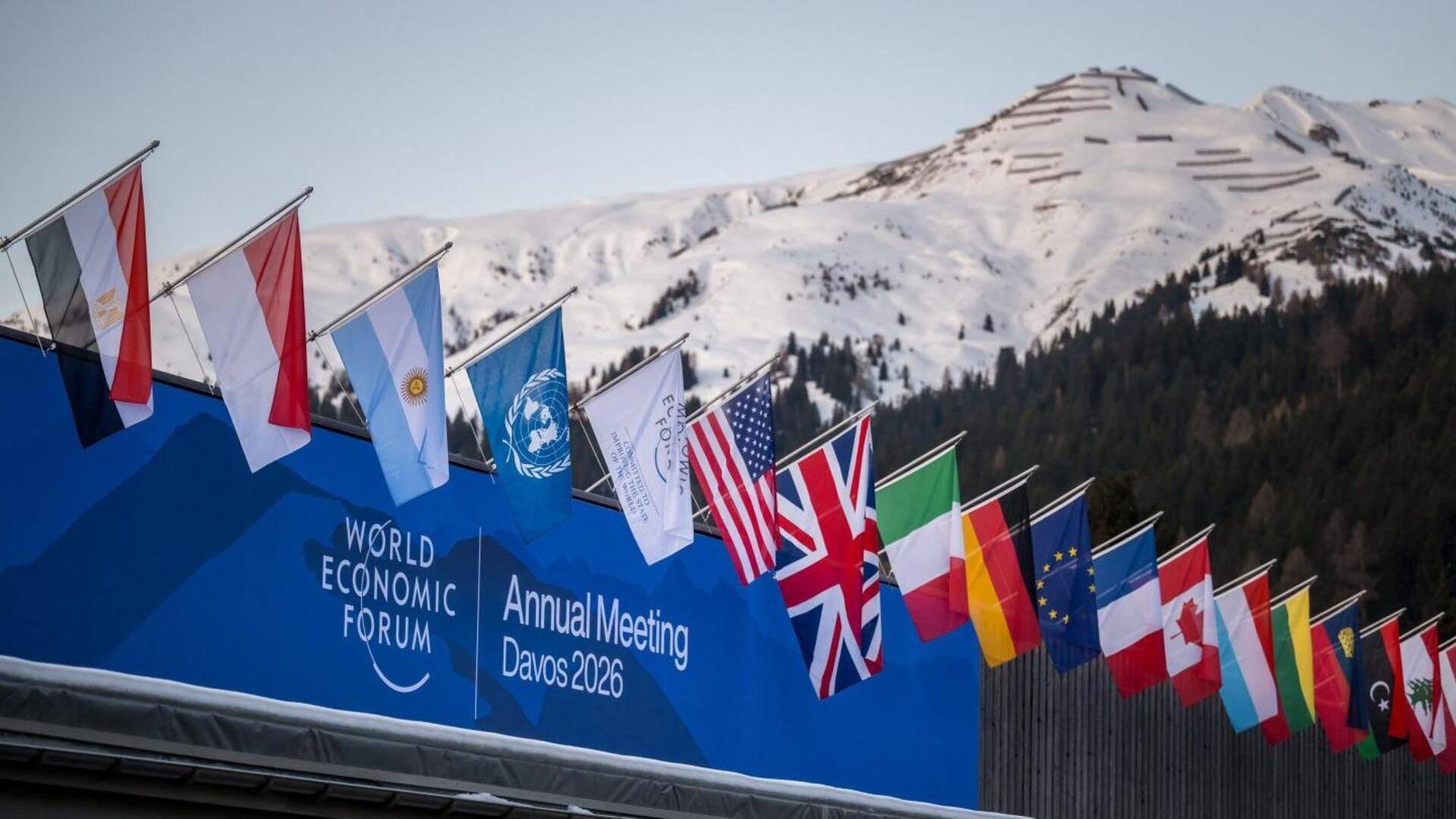 National flags in front of snow-covered mountains